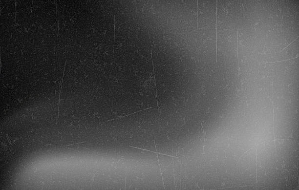 istock Retro Black and White Film Frame with Light Leaks, Abstract black andwhite background with vintage film effect, soft light leaks, and grain texture reminiscent of old cinema frames. Vector 2254474575