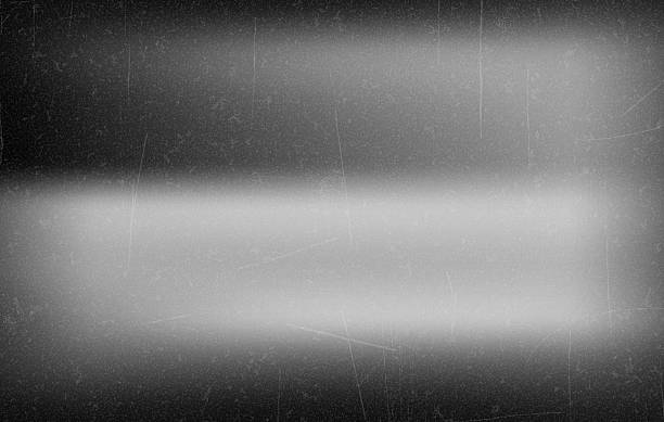 istock Retro Black and White Film Frame with Light Leaks, Abstract black andwhite background with vintage film effect, soft light leaks, and grain texture reminiscent of old cinema frames. Vector 2254474641