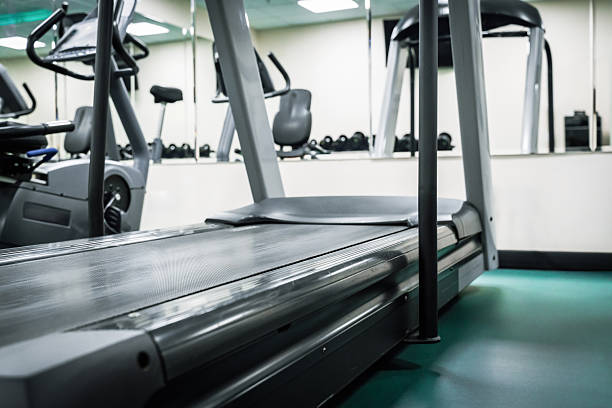 istock Treadmill in a gym with exercise equipment and workout area in daylight 2254476630