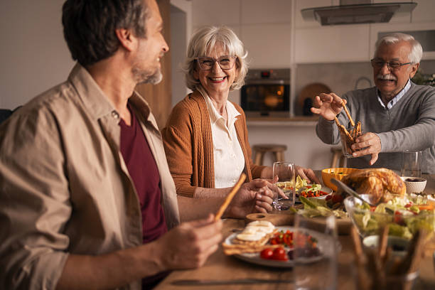 istock Warm Family Dinner With Laughter And Shared Food In A Modern Kitchen 2254477237