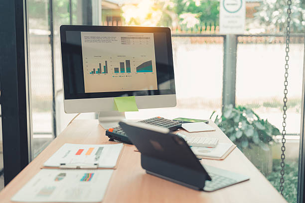 istock Two accountants use calculators to perform company financial calculations, handle accounting on laptop computers at their desks, manage budgets, and handle financial tasks. 2254480473