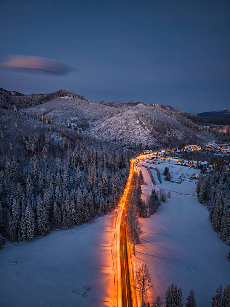 istock Winding Snowy Road at Dusk 2254481163