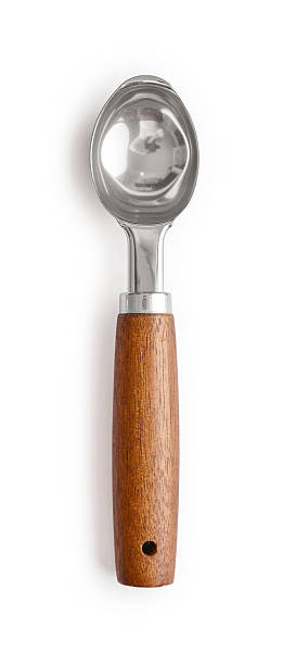 Stainless steel ice cream spoon with wooden handle isolated on white background, clipping path included.