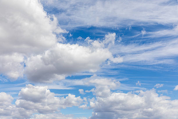 istock Soft white clouds float across a clear blue sky, creating a serene atmosphere during a sunny afternoon. The scene invites a sense of calm and peace in nature. 2254481777