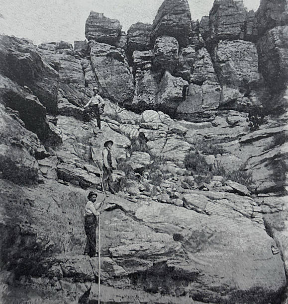 istock Antique illustration - men climbing a rock formation in New Mexico 2254490164