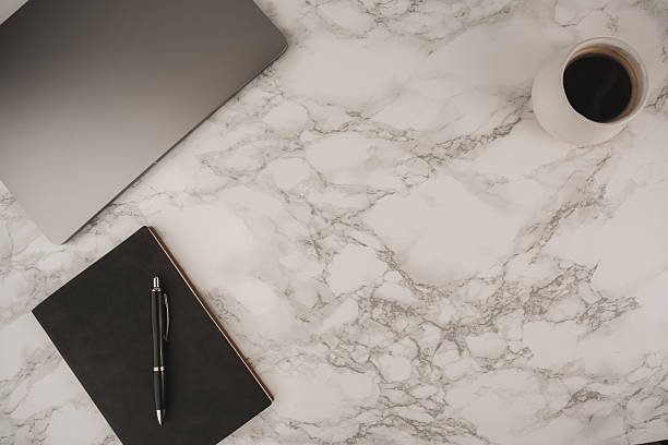 istock A clean workspace features a laptop, a cup of coffee, and a notebook on a marble surface. This setting offers ample negative space for text and inspiration, perfect for work or study 2254492865
