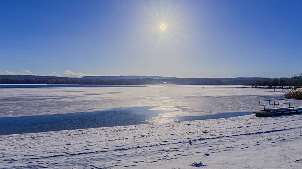 Winter sun at blue sky over the Brombachsee lake