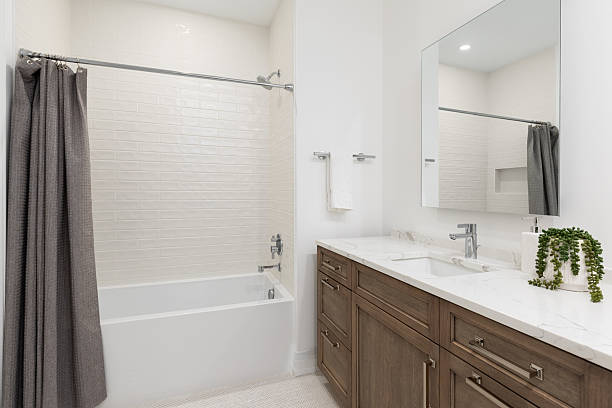 istock A bathroom with a wood cabinet, herringbone flooring, and subway tile shower. 2254493008