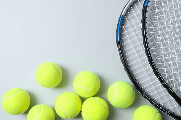 istock Tennis rackets and balls on a gray background 2254493590
