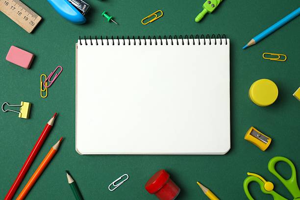 istock Flat lay with open notebook school stationery on green background, top view 2254495360