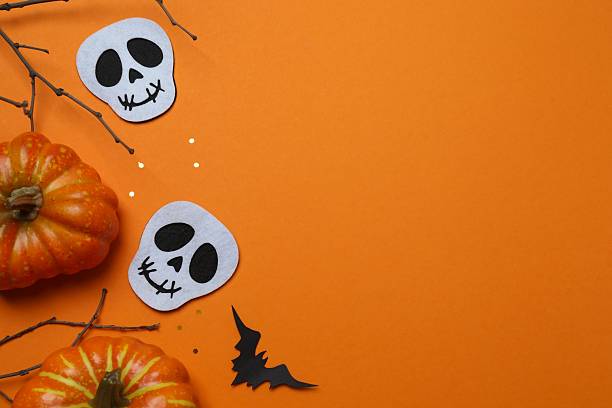 istock Halloween postcard with festive decorations on orange background . Top view, space for text 2254495392