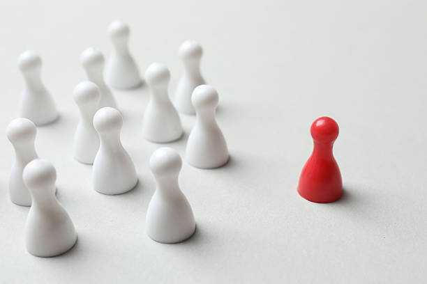 istock Group of pawns on a light background 2254496268