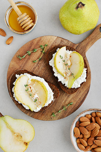 istock Bruschetta with cream cheese, honey, pear, thyme 2254496451