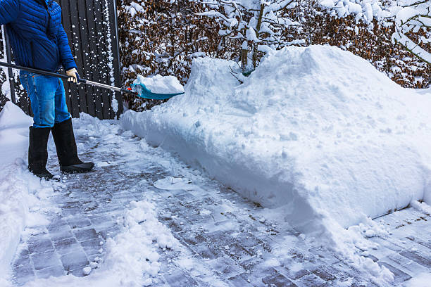 istock Close up view of person removing deep snow from villa driveway using shovel during cold winter day. Sweden. 2254498039