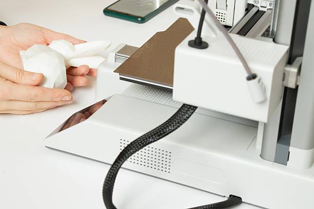 istock A desktop 3D printer and a white low-poly bunny on the printer, along with female hands, technologies for additive manufacturing 2254498088