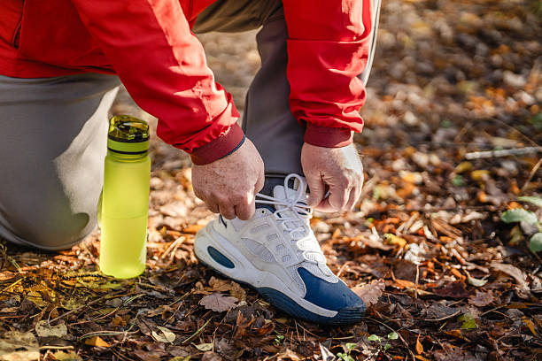 istock Plus-size elderly jogger tying his shoes 2254499070