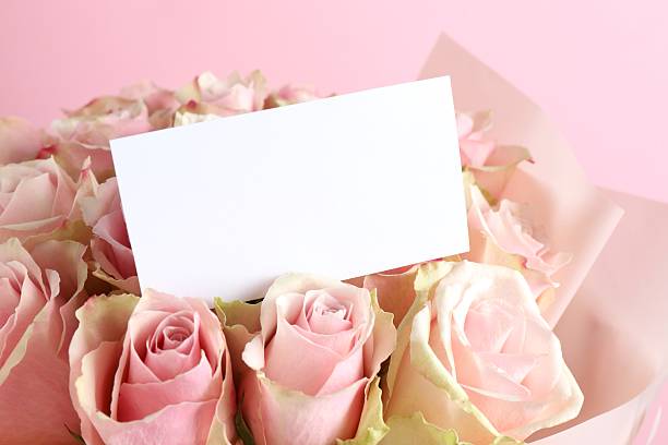 Empty yellow paper for copy space with flower bucket on colored background. Mock up of greeting or invitation card with flat lay style, top view