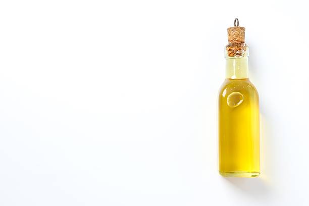 Bottle of fresh oil on white background