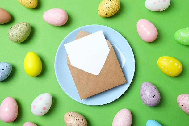 istock Happy Easter. Top photo with blue plate, eggs and paper envelope on color background with empty space 2254502503