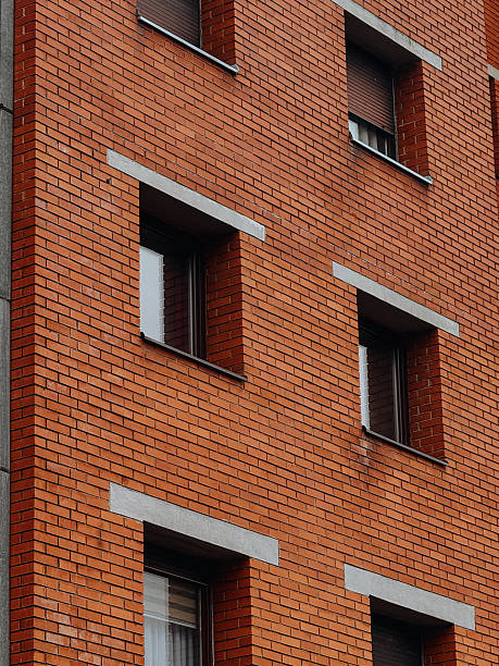 istock Red brick building facade with rows of windows and shutters in Bihac 2254508261