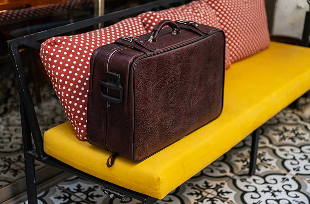 Vintage brown leather suitcase on sofa