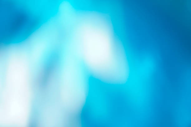 An abstract blue background design with bokeh effects that evoke the texture of water and the light of the deep ocean, blending waves of movement and natural brightness in an illustration of blurred art