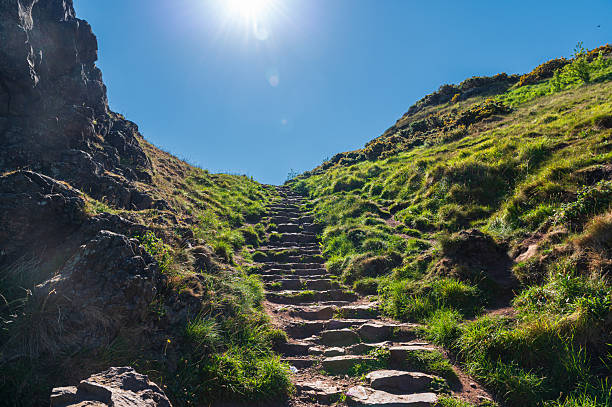 Stone steps going up to Arthur's Seat viewpoint, Holyrood Park, Edinburgh, Scotland, bright sunny day, sun in the front