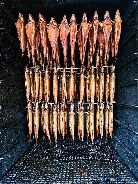 Smoked fish hanging inside a traditional smokehouse