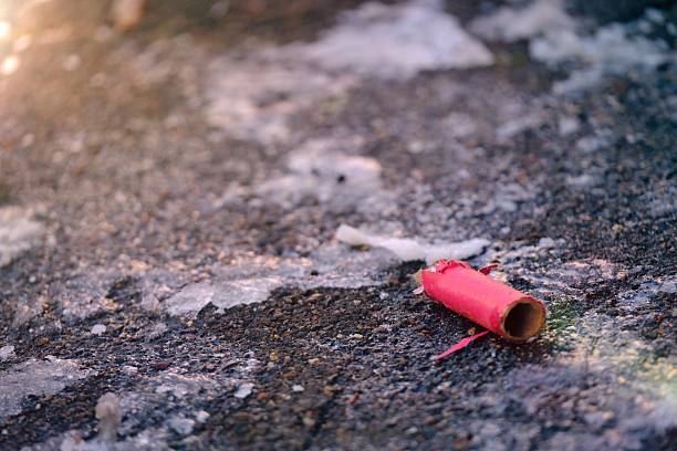istock Waste of firework lying on a snow-covered street. Horizontal image with copy space. 2254513442