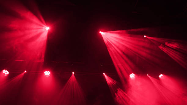istock Abstract Background Of Red Stage Light On Concert Stage Through Smoke 2254514860
