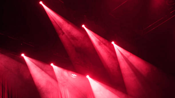 istock Red Stage Light Shines On Concert Stage Through Smoke 2254514908
