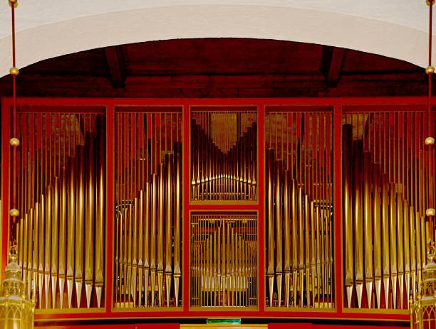 The organ in Narvik church showcases a blend of wood and metal, standing tall against a simple backdrop. It highlights craftsmanship and serves as a focal point in this travel destination.