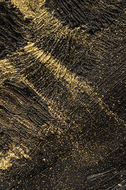 istock Macro texture of black paint with gold glitter 2254517277