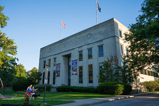 Rochester, USA - August 31, 2025. A senior couple walking dog in front of Rochester Museum of Arts and Sciences, Rochester, New York, USA
