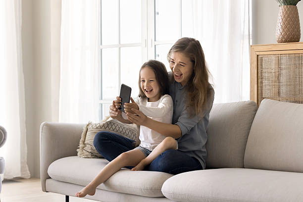 istock Happy mother and daughter make videocall use smartphone 2254521105