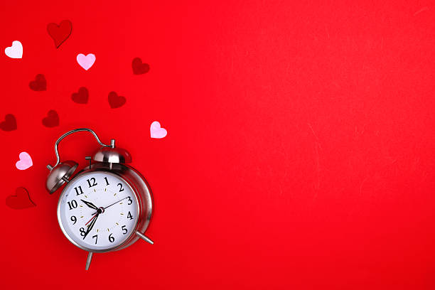 istock Valentine's Day. Alarm clock on a red background and hearts. Space for text. 2254521851