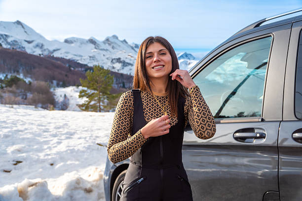 istock Woman smiling during winter road trip with mountains 2254522132