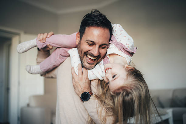 istock Father and carrying daughter on shoulders 2254529637