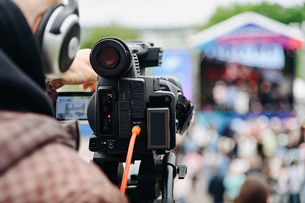istock large black video camera on tripod outdoors 2254531785
