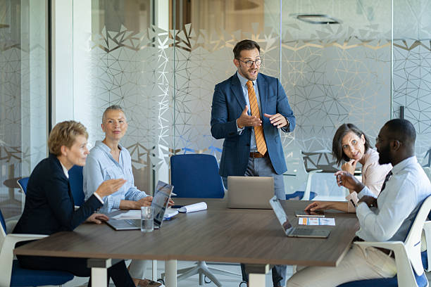istock Enthusiastic businessman leading a presentation during office meeting 2254531823