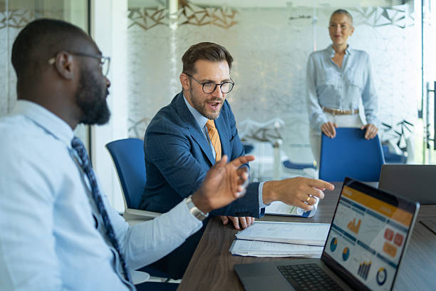 istock Business team analyzing financial data on laptop in modern office 2254531825