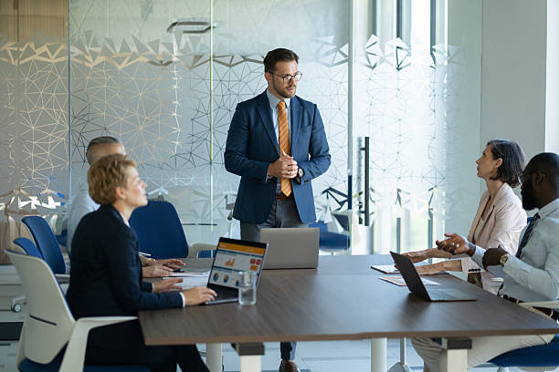 istock Businessman leading a meeting in a modern office 2254531826