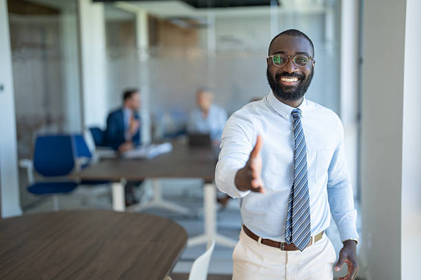 istock Smiling businessman offering handshake in modern office 2254531852