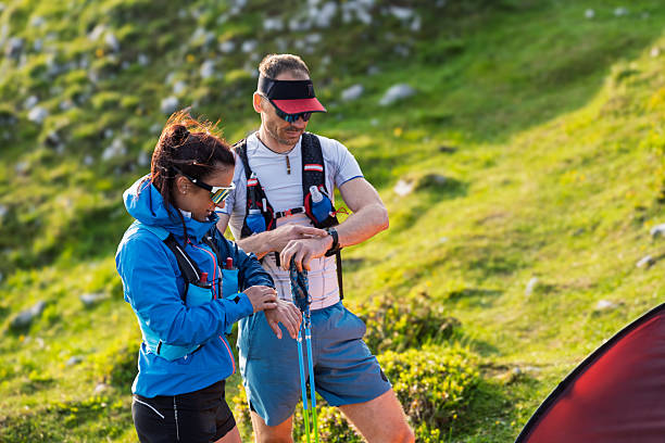 istock Hikers on a Mountain Slope with an Orange Tent 2254536106