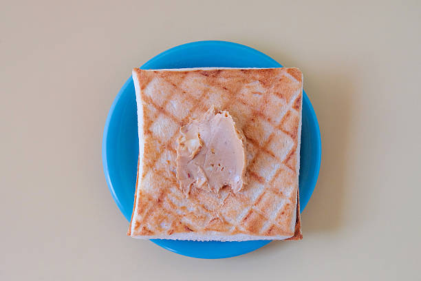 Delicious sandwich with peanut butter on top.