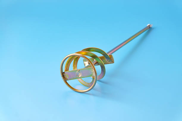 Paddle mixer for cement adhesive mortar connects to electric drill .