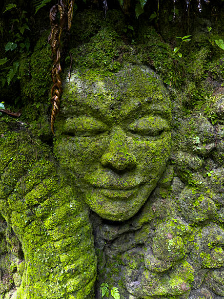 Asian, Balinese statue with green background.