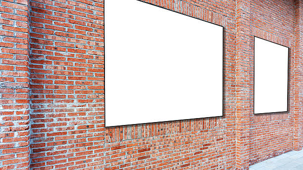 istock Blank advertising panels on a brick wall 2254536651