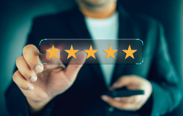 istock Businessman hands holding a smartphone and a five-star rating bubble. 2254537907