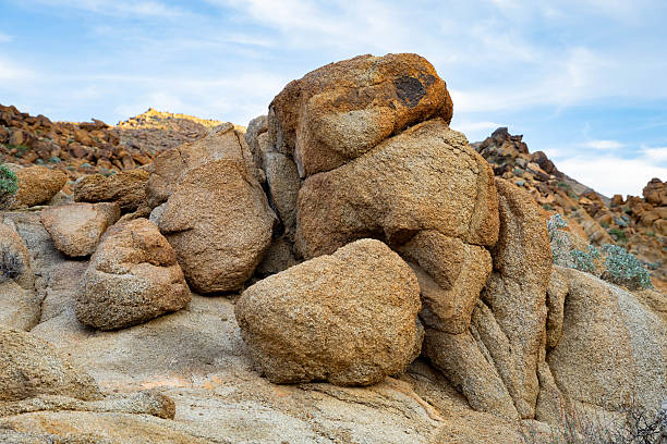 Vast collection of eerie shaped rock formations covering the desert floor with Horseshoe Meadows Road zig-zagging up a distant mountain slope as seen from the Alabama Hills near Lone Pine, California.